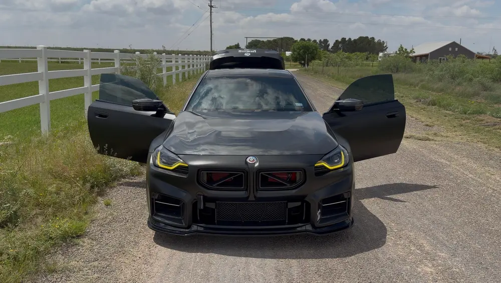 Marco's BMW M2 on a gravel road with both doors open